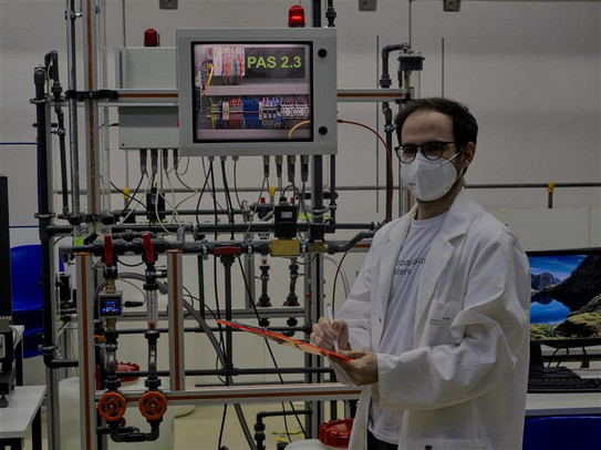 Inauguration of the newly constructed student lab "double tank system". Prof. Lucia standing in front of the system, ready for the initial startup. 